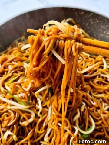 Hot noodles being picked up by a pair of chopsticks