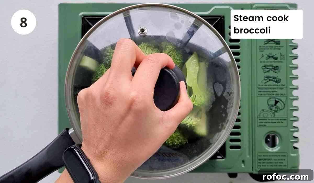 Beef and Broccoli Stir-Fry Noodles Recipe 8 cooking broccoli in a saucepan with caption
