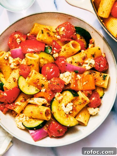 Red Chimichurri Pasta Recipe — Serve Hot or Chilled 19 Red Chimichurri Pasta with zucchini, tomatoes, and feta on a plate.