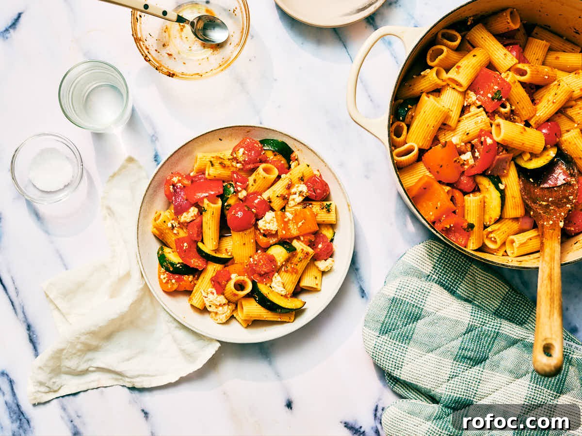 Red Chimichurri Pasta Recipe — Serve Hot or Chilled 3 A pot of Red Chimichurri Pasta being served into bowls.