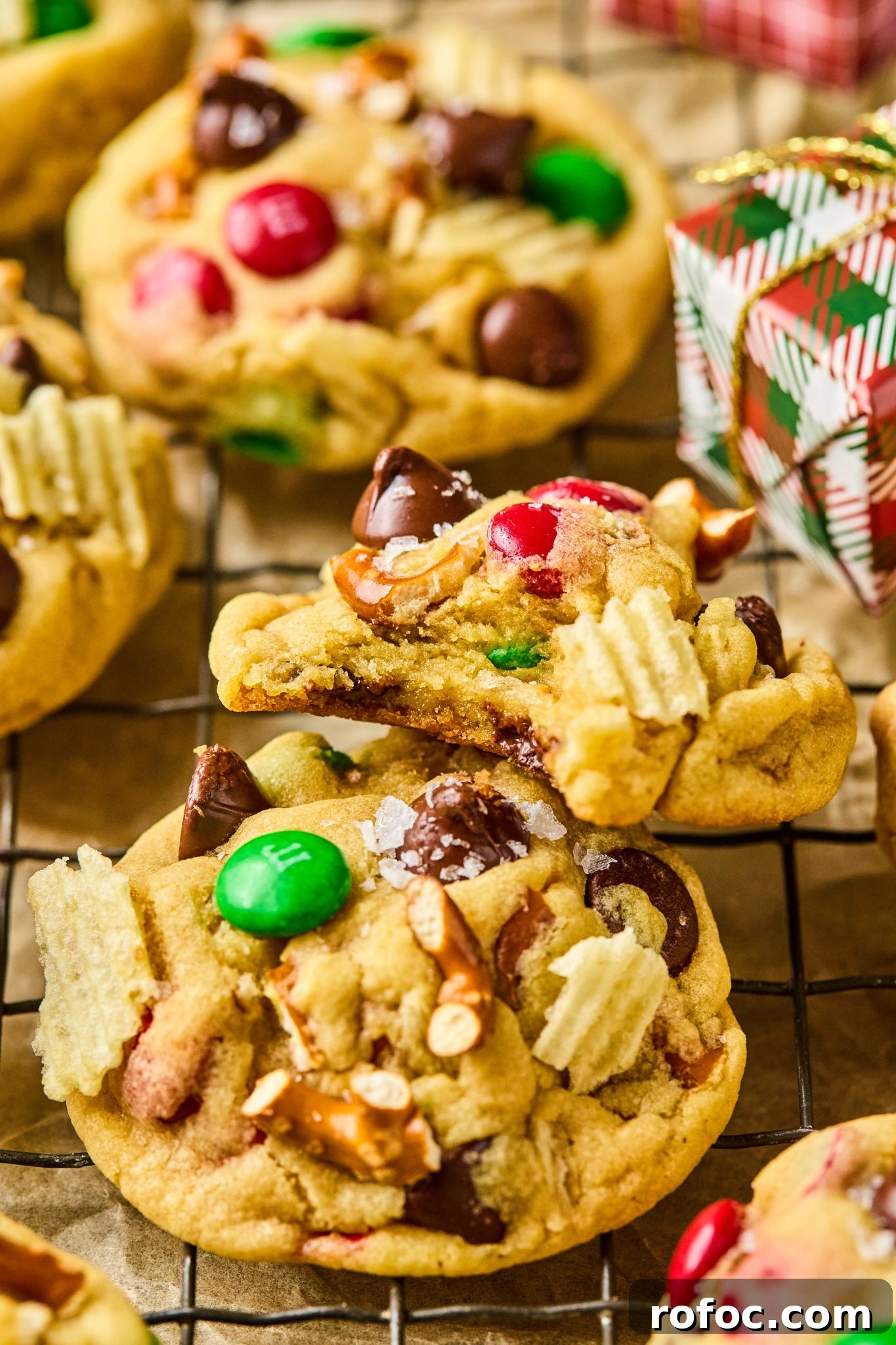 Santa’s Trash Cookies: Festive No-Bake Candy Cookie Recipe 2 a bite taken out of a cookie filled with wavy cheese, pretzels, and chocolate.