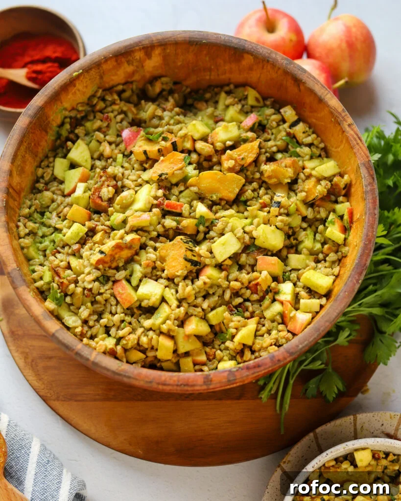Farro Salad with Apples and Roasted Delicata Squash 5 serving homemade fall farro apple salad with roasted squash, parsley, pecans and more next to smoked paprika, fresh parsley, and apples on a serving table.