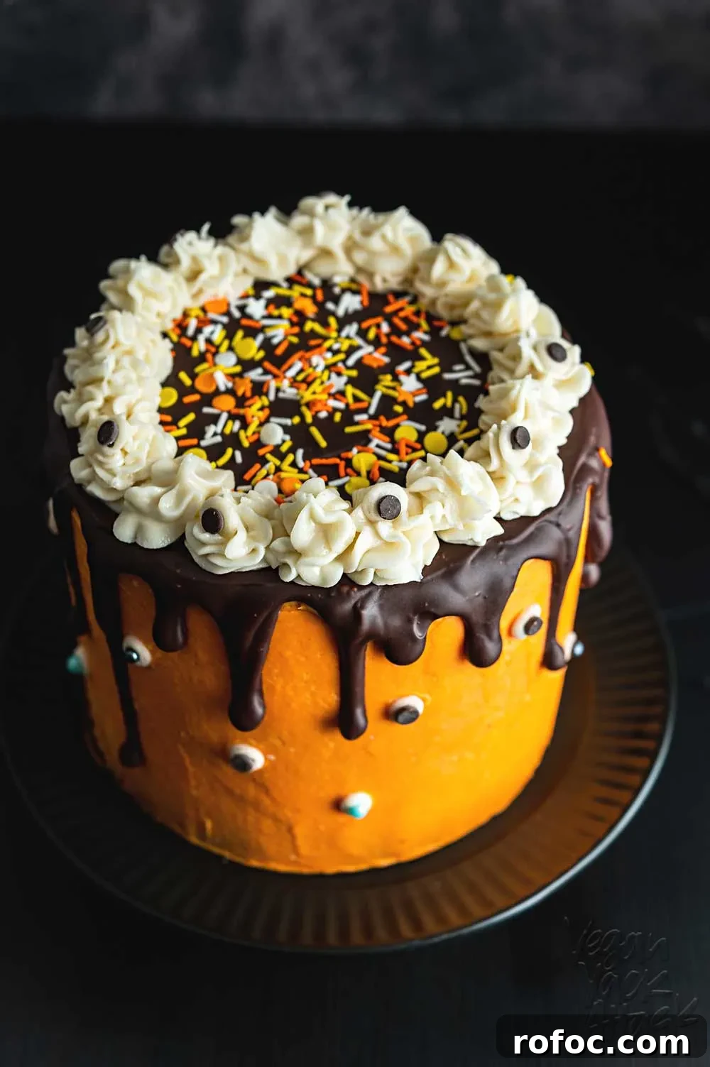 Vegan Pumpkin Chocolate Marble Cake with Silky Ganache 6 Orange frosting covered a marbled layer cake, with sprinkles