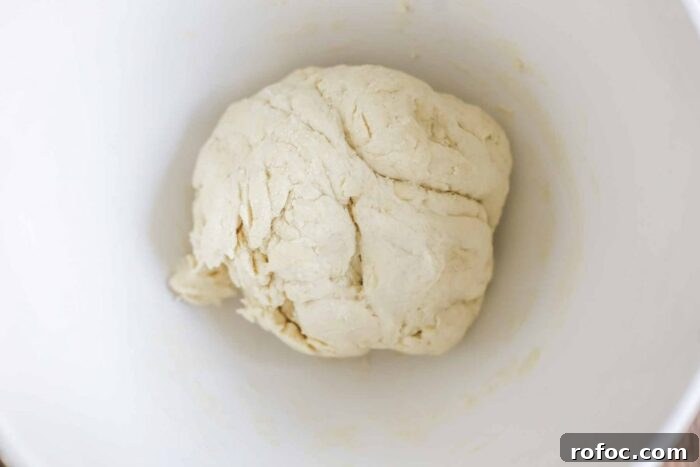 Sourdough Flatbread Recipe Using Active Starter or Discard (No Yeast) 8 sourdough flatbread dough kneaded in a white ceramic stand mixer bowl
