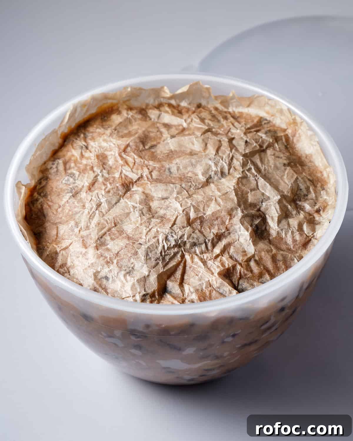 Photo of pudding basin filled with christmas pudding mixture with the greaseproof paper circle placed on top.