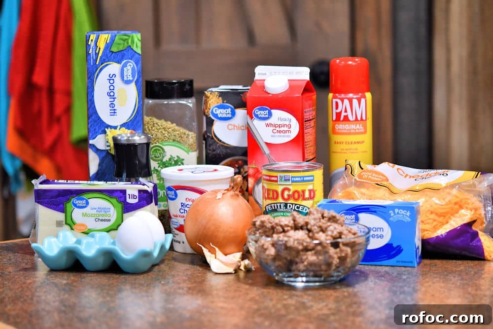 Ingredients for baked spaghetti casserole shown on a counter top, referenced in the recipe card individually