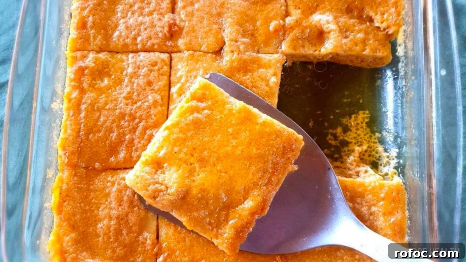 15 Low-Carb Recipes That Taste Like You Spent Hours 16 A rectangular glass dish with golden-brown, square-cut cornbread, with one piece being lifted by a metal spatula.