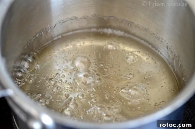 How to Make Caramels | fifteenspatulas.com Clear Sugar Syrup Boiling in Saucepan