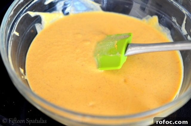 Pumpkin Soft Caramels Recipe | fifteenspatulas.com pumpkin soft caramels candy mixture in glass bowl