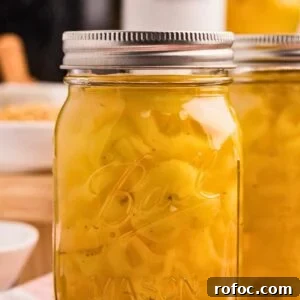 How to Can Homemade Pickled Banana Peppers for Long-Term Storage 11 front close up shot of one jar with another edge of the jar in the background.