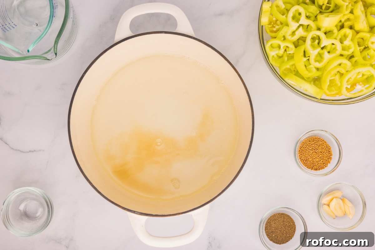 How to Can Homemade Pickled Banana Peppers for Long-Term Storage 5 brine in pot.