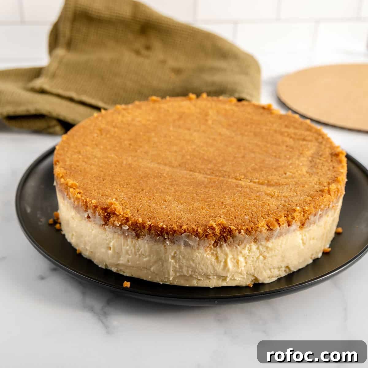 Decadent Cherry Cheesecake Recipe with a Buttery Crust 15 The finished cheesecake turned out onto a black dinner plate.