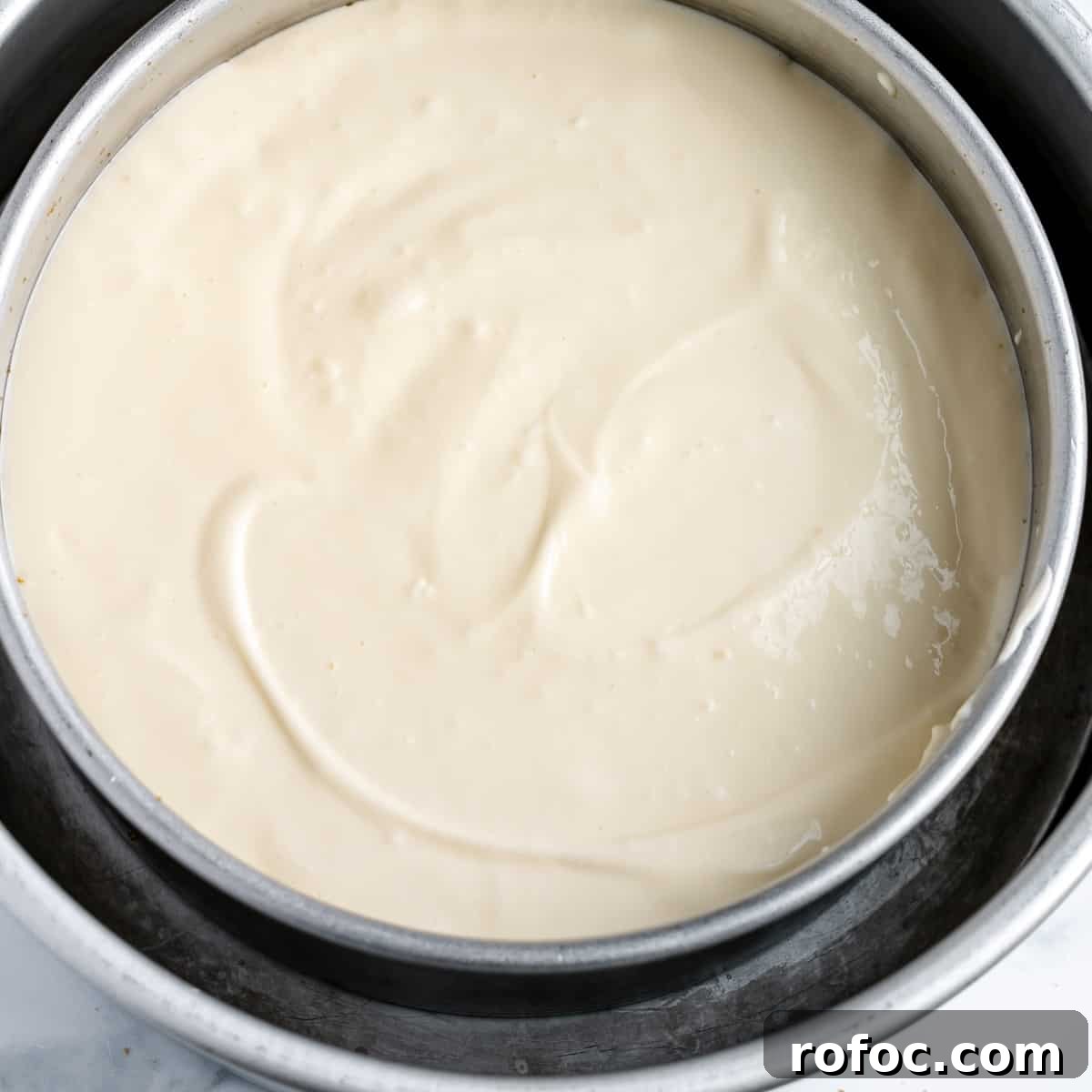 Decadent Cherry Cheesecake Recipe with a Buttery Crust 7 Cheesecake batter in a pan, sitting in a larger cake pan