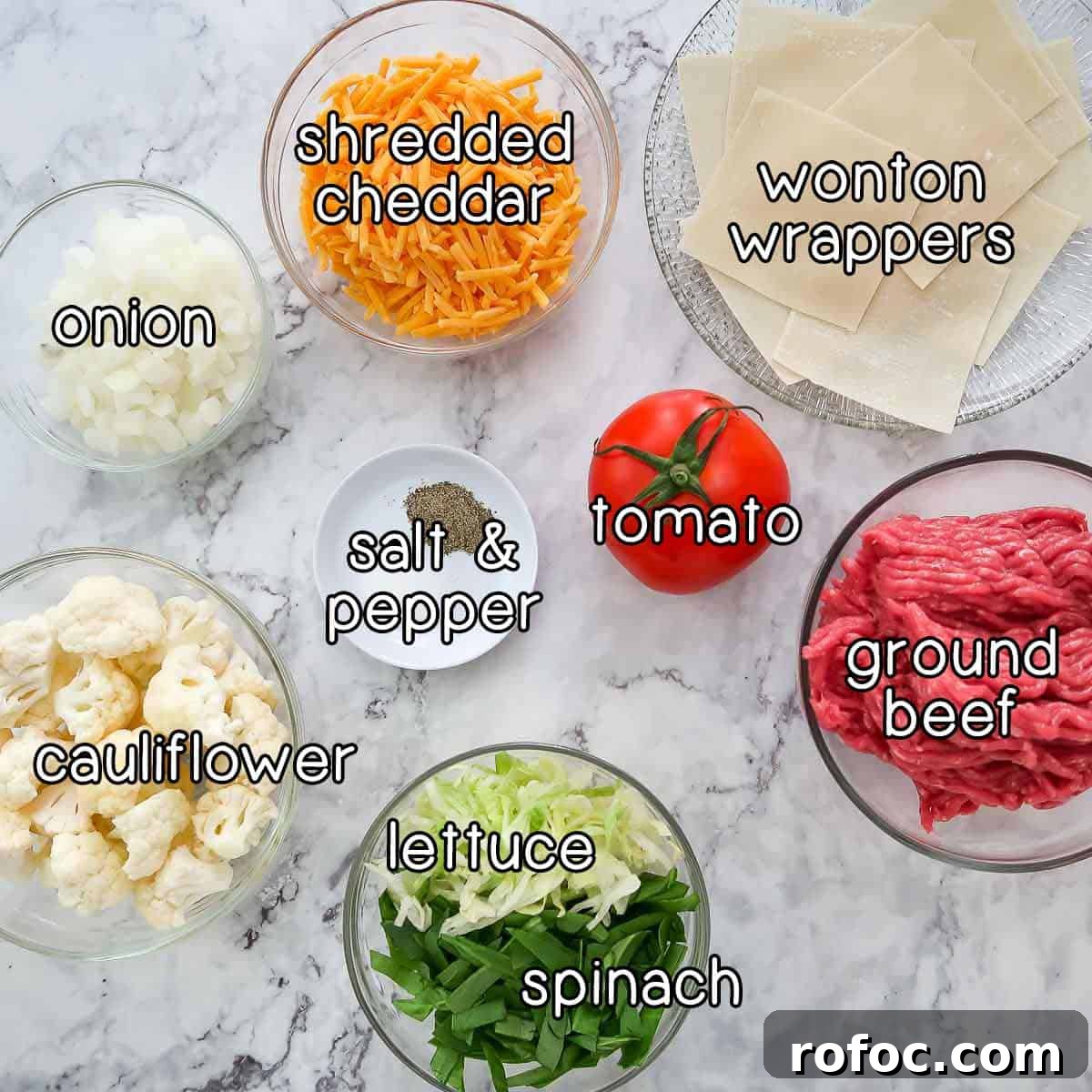 Wonton Cheeseburger Cups: Mini Cheeseburger Bites in Crispy Wrappers 3 Overhead shot of ingredients- wonton wrappers, shredded cheddar cheese, onion, tomato, ground beef, lettuce, spinach, cauliflower, salt, and pepper.