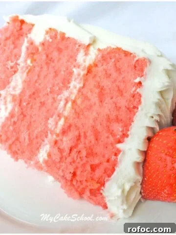 Slice of three layer strawberry cake from cake mix on a plate