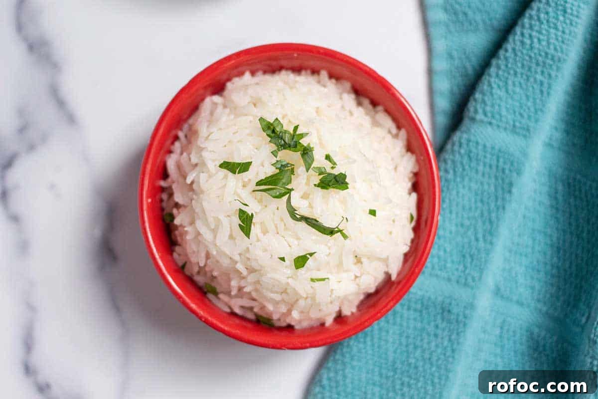 Perfect Jasmine Rice in the Instant Pot: Fluffy & Quick 8 Jasmine rice in a small bowl garnished with fresh parsley.