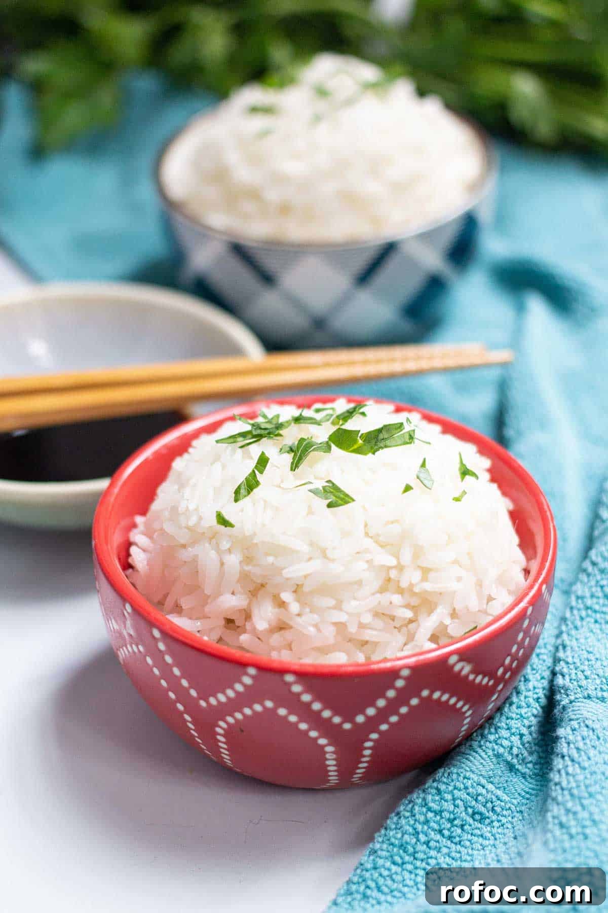 Perfect Jasmine Rice in the Instant Pot: Fluffy & Quick 9 Cooked jasmine rice in a small bowl topped with fresh parsley.