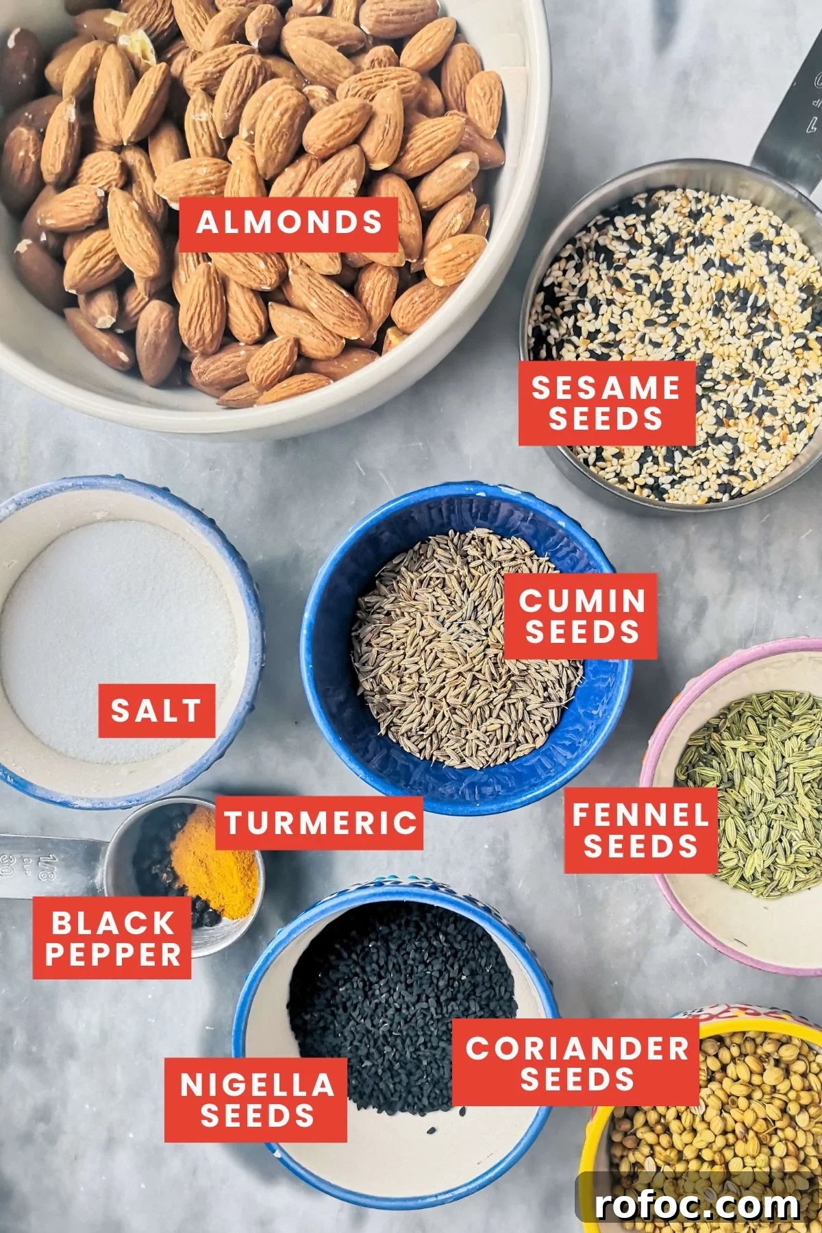 Spiced Dukkah Recipe: Crunchy Egyptian Nut & Spice Mix 3 Dukkah ingredients laid out on a grey marble background.