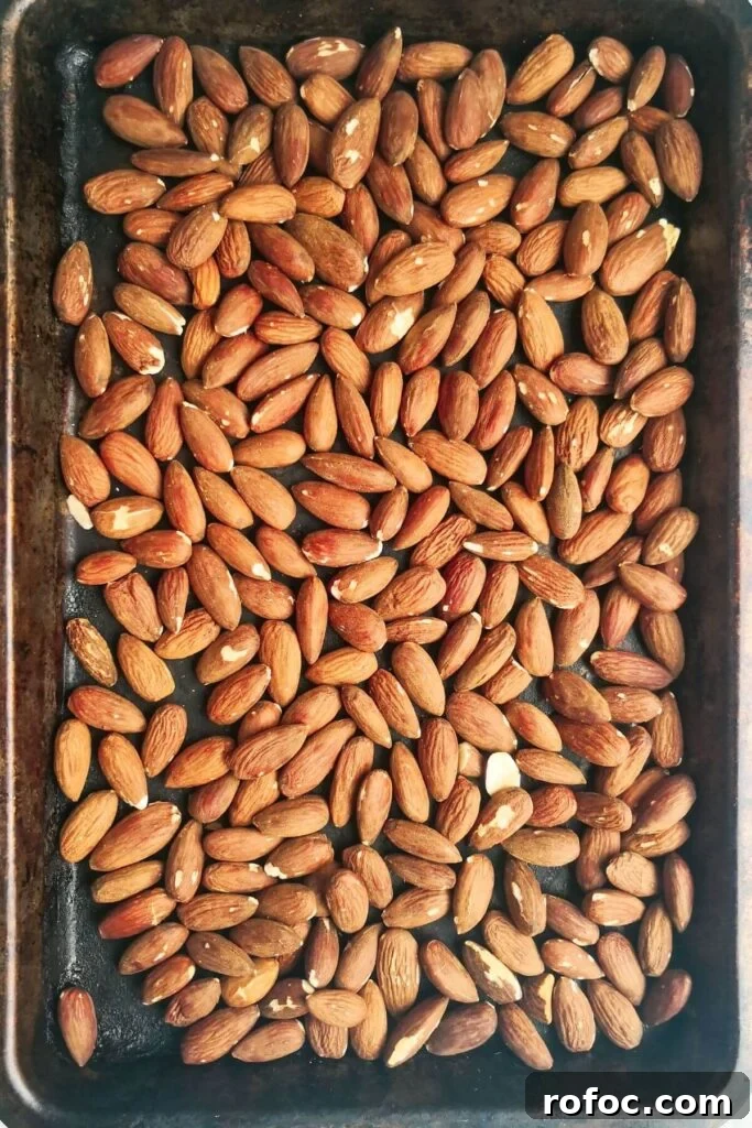 Spiced Dukkah Recipe: Crunchy Egyptian Nut & Spice Mix 5 Roasted almonds laid out on an oven tray.