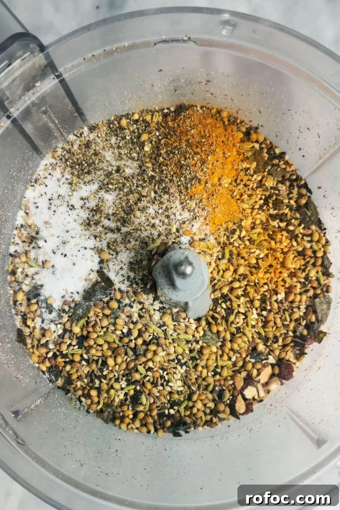 Spiced Dukkah Recipe: Crunchy Egyptian Nut & Spice Mix 6 Dukkah ingredients in the bowl of a food processor.