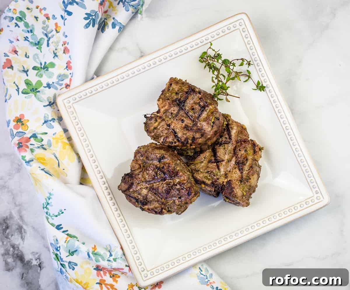 19 Fall Cookout Recipes for Sunday Dinner and Game Day 8 Smoked lamb chops on a white plate with a green napkin.