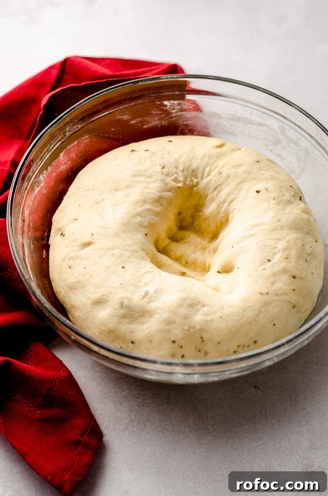 Baking with Yeast: A Practical Guide for Soft, Flavorful Bread 8 pizza pull apart bread dough that has been punched down in a glass bowl