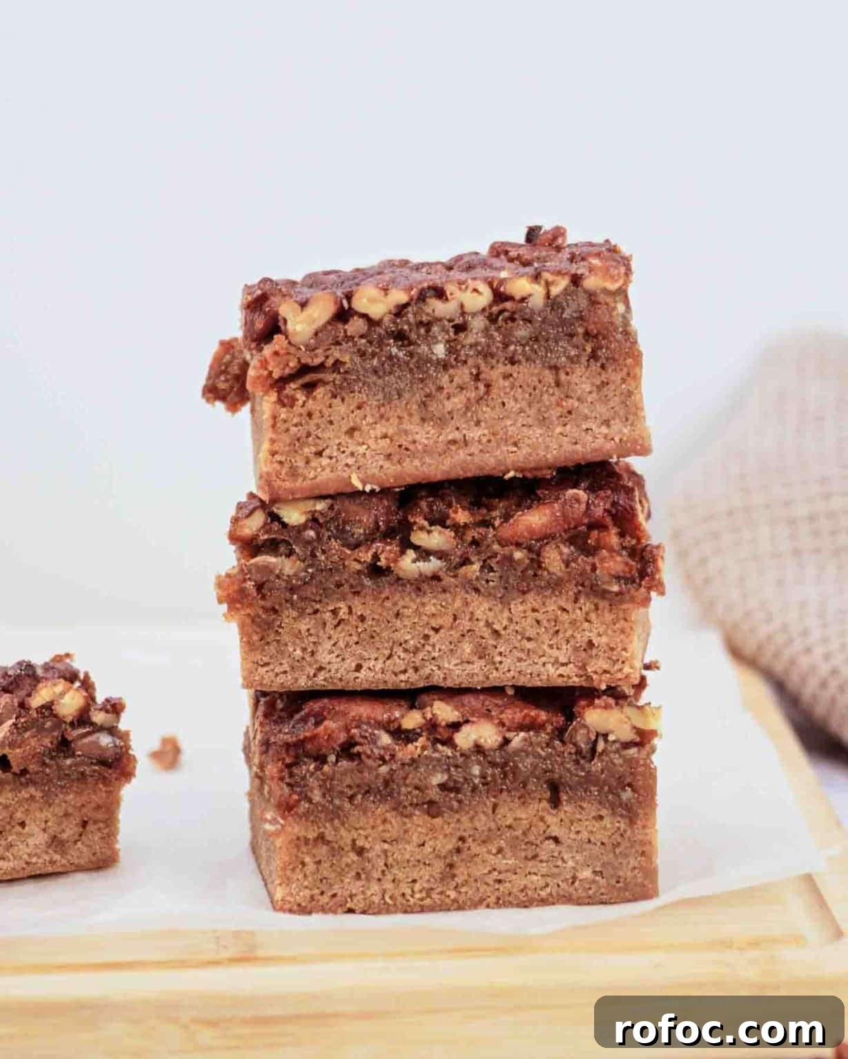 Derby Pie Brownies: Classic Kentucky Derby Dessert Recipe 13 Derby pie brownies with chocolate chips and pecans on parchment paper - Kentucky Derby desserts - Hostess At Heart
