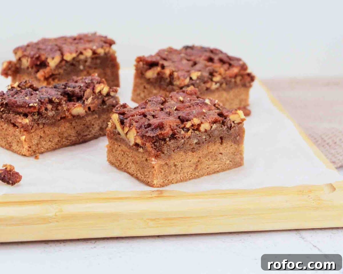 Derby Pie Brownies: Classic Kentucky Derby Dessert Recipe 14 Close up of cut pieces of fudgy bourbon brownie layer with pecan pie topping - Hostess At Heart