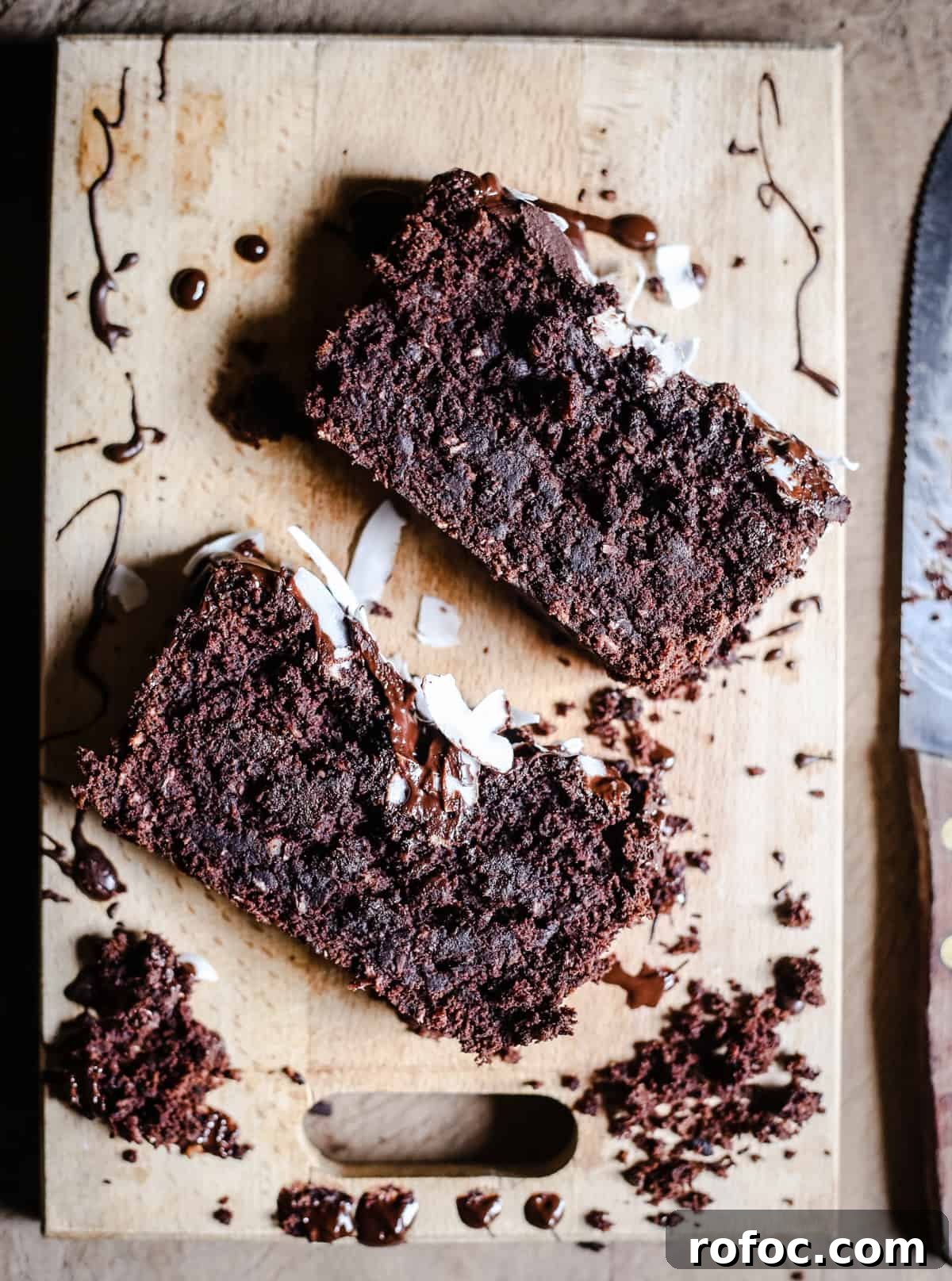 Vegan Chocolate Banana Coconut Bread Recipe — Moist & Decadent 3 slices of Vegan Chocolate Coconut Banana Bread on a wooden board