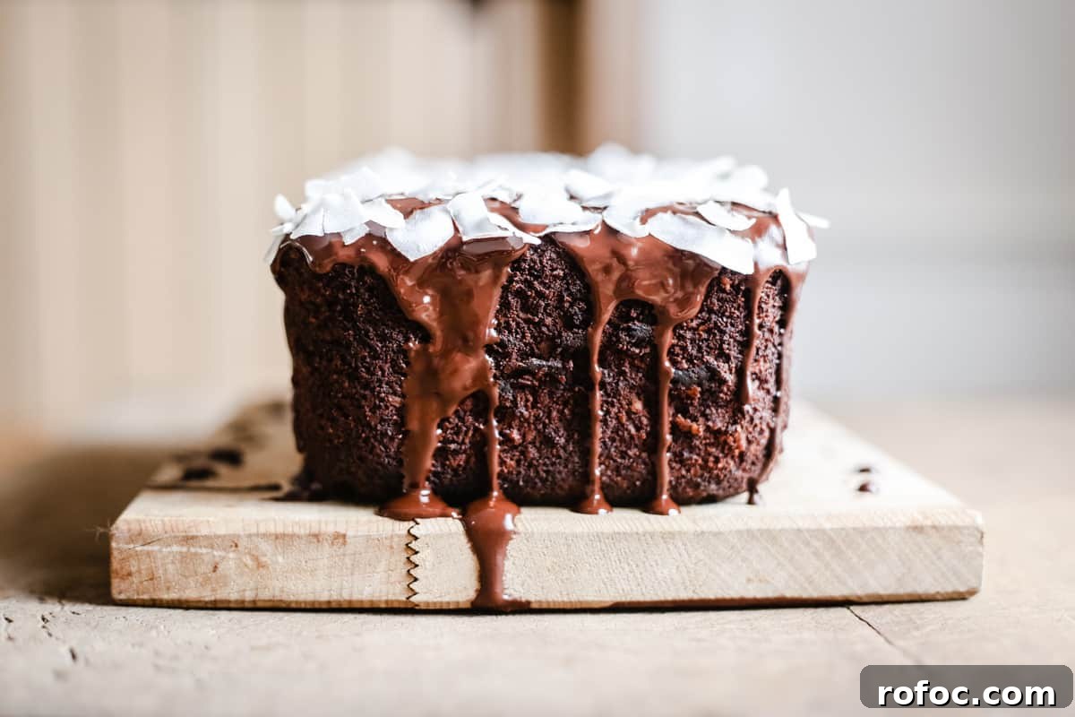 Vegan Chocolate Banana Coconut Bread Recipe — Moist & Decadent 4 Vegan Chocolate Coconut Banana Bread on a wooden board