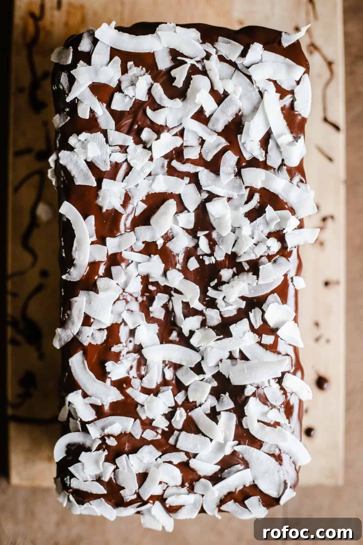 Vegan Chocolate Banana Coconut Bread Recipe — Moist & Decadent 5 overhead shot of Vegan Chocolate Coconut Banana Bread on a wooden board