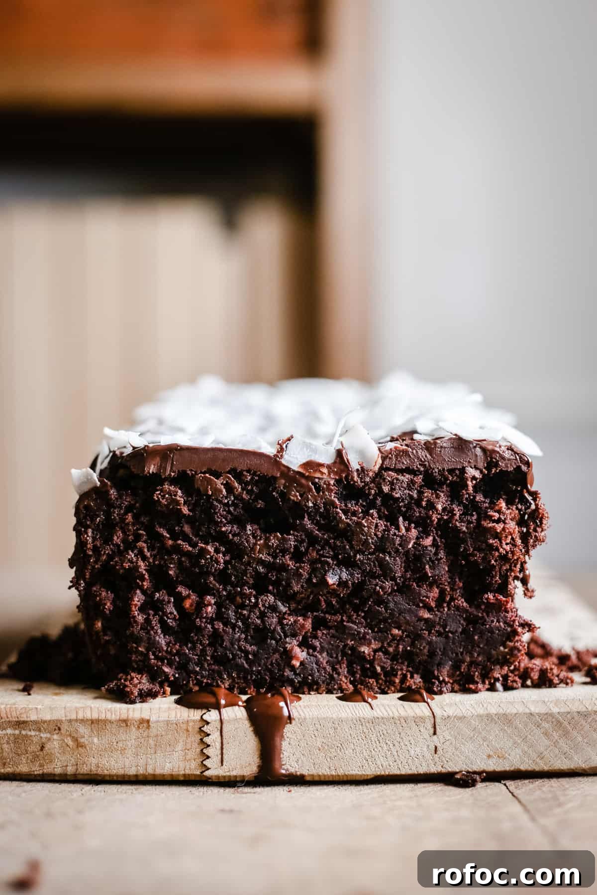 Vegan Chocolate Banana Coconut Bread Recipe — Moist & Decadent 6 Vegan Chocolate Coconut Banana Bread on a wooden board
