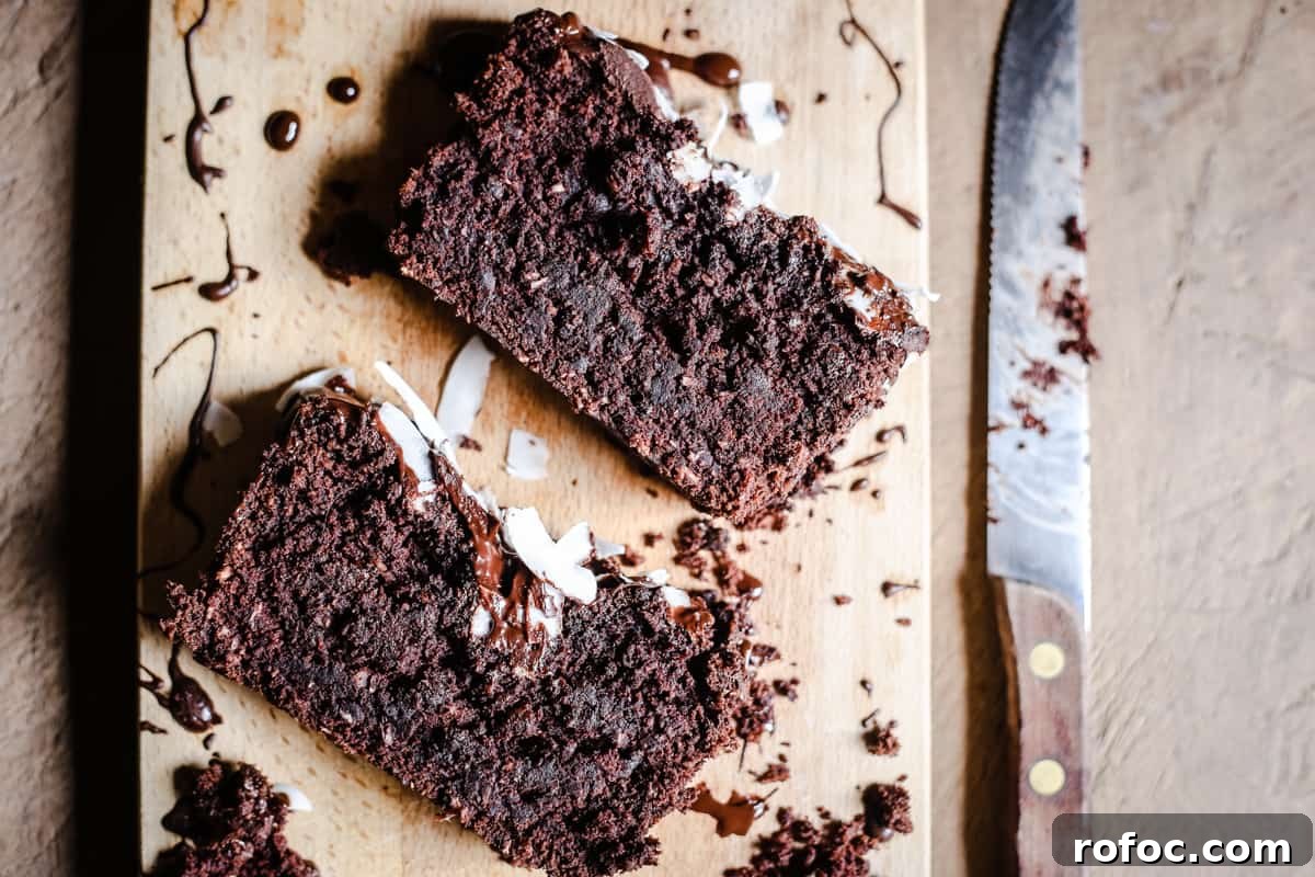 Vegan Chocolate Banana Coconut Bread Recipe — Moist & Decadent 7 slices of Vegan Chocolate Coconut Banana Bread on a wooden board