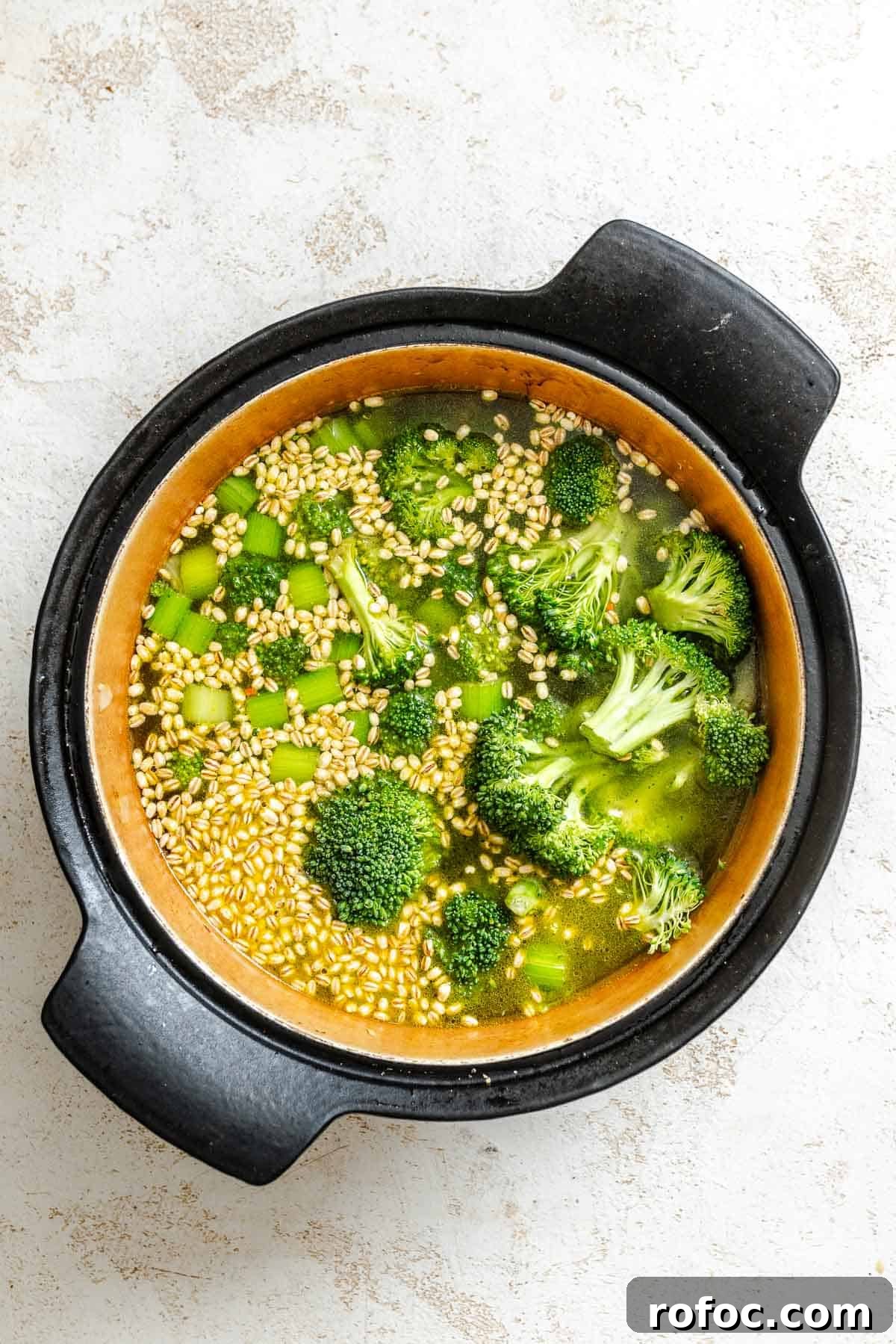 Hearty Vegetable and Barley Soup Recipe for Cozy Meals 5 Process shot showing veggies added to pot.