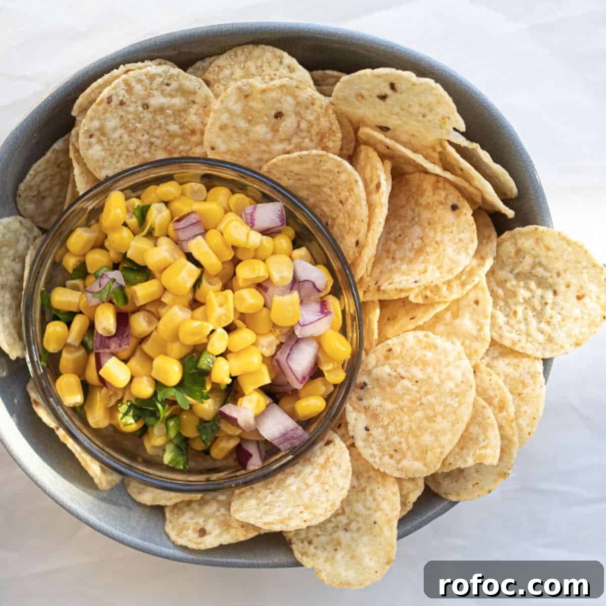 chipotle corn salsa in a small bowl surrounded by corn chips
