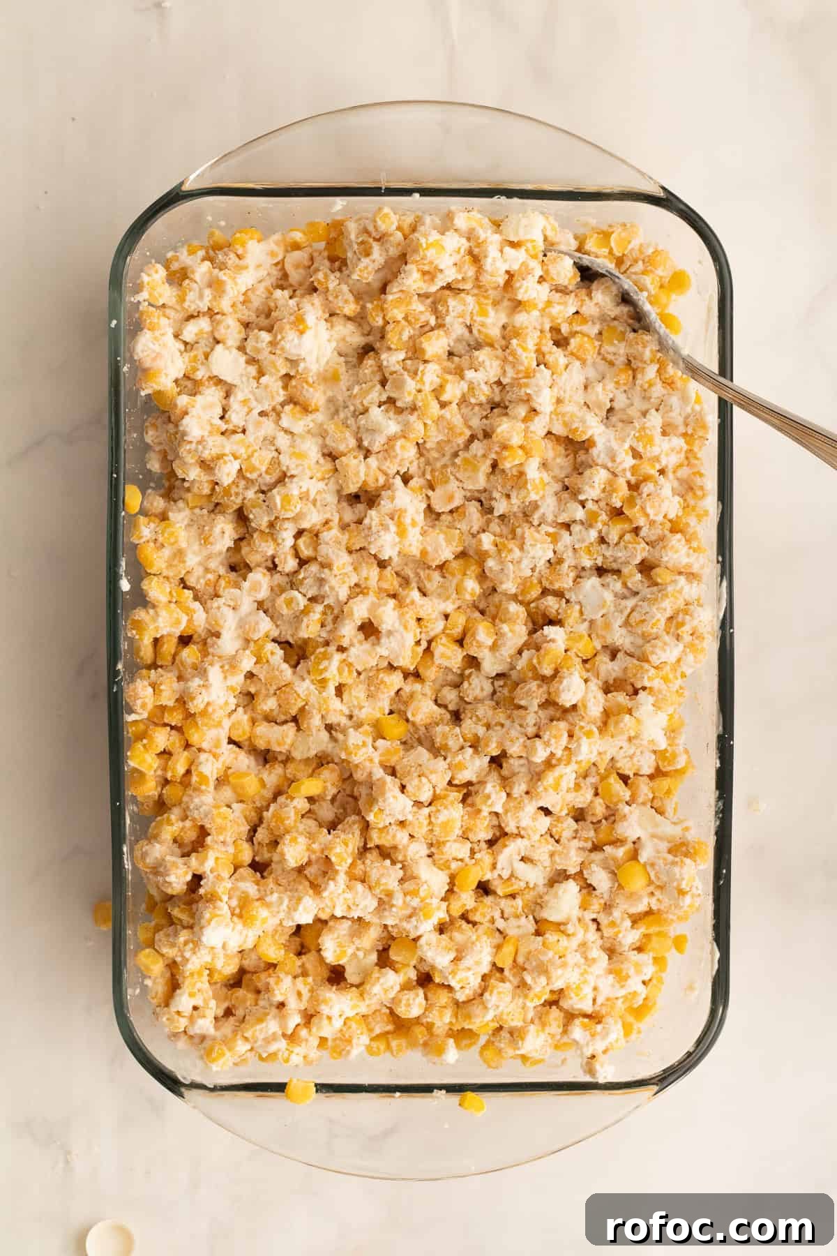 6-Ingredient Mexican Street Corn Casserole Recipe 5 ingredients mixed together for mexican corn casserole in a glass dish