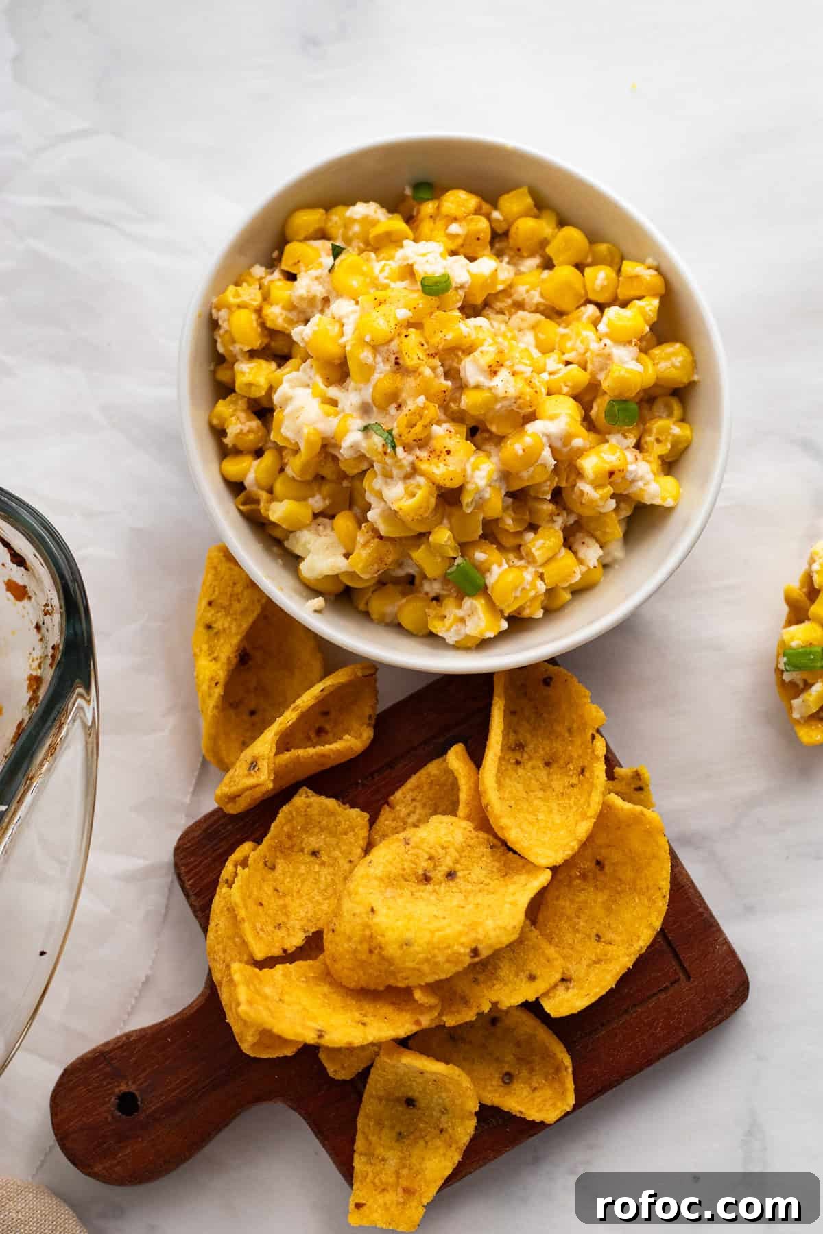 6-Ingredient Mexican Street Corn Casserole Recipe 7 corn in a white bowl with corn chips on serving dish