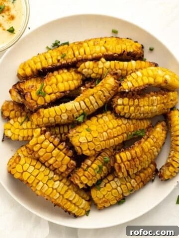 corn ribs piled on a white plate