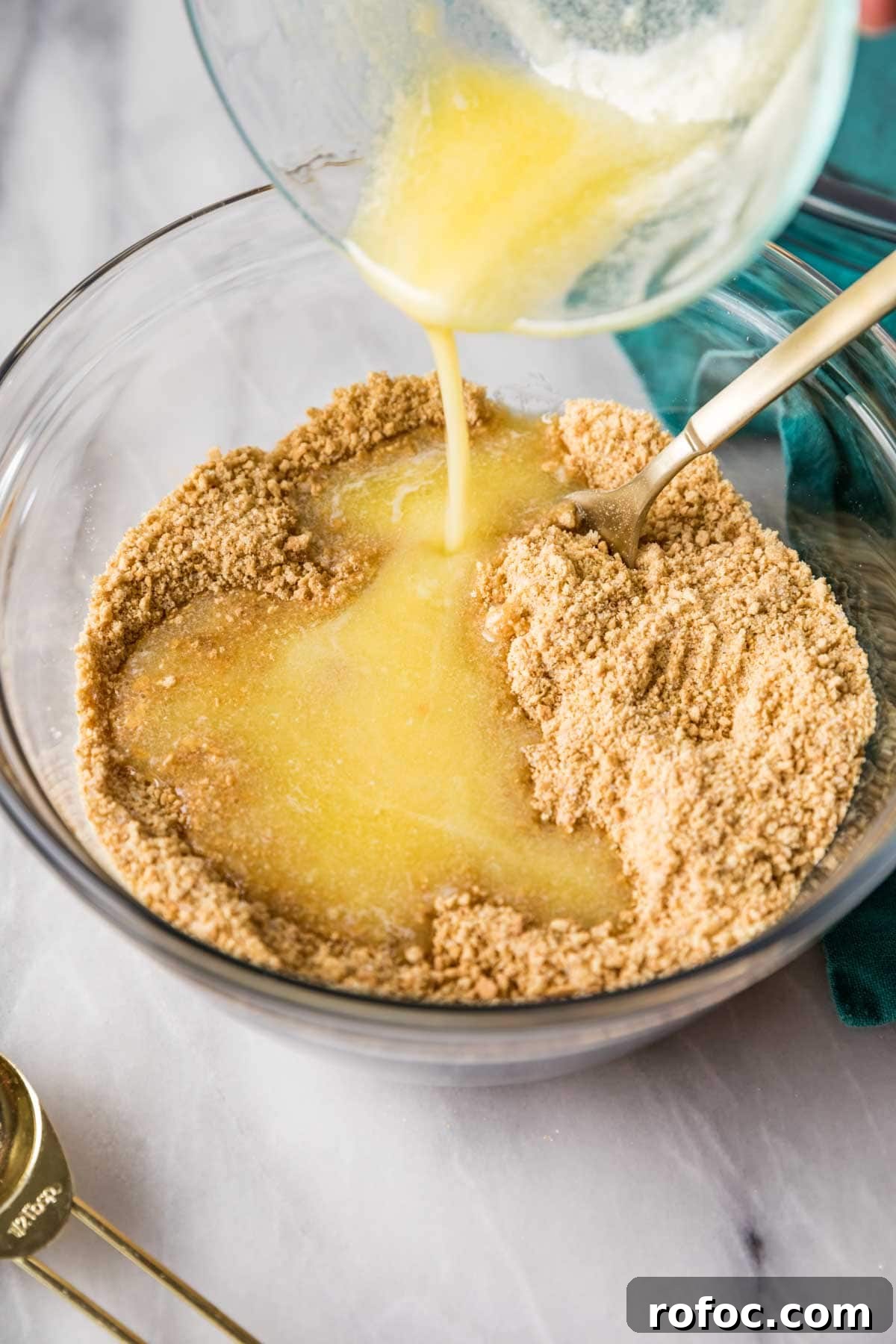 Graham Cracker Crust Recipe: Simple Steps for Perfect Pie Crust 6 Melted butter being poured into graham cracker crumbs.