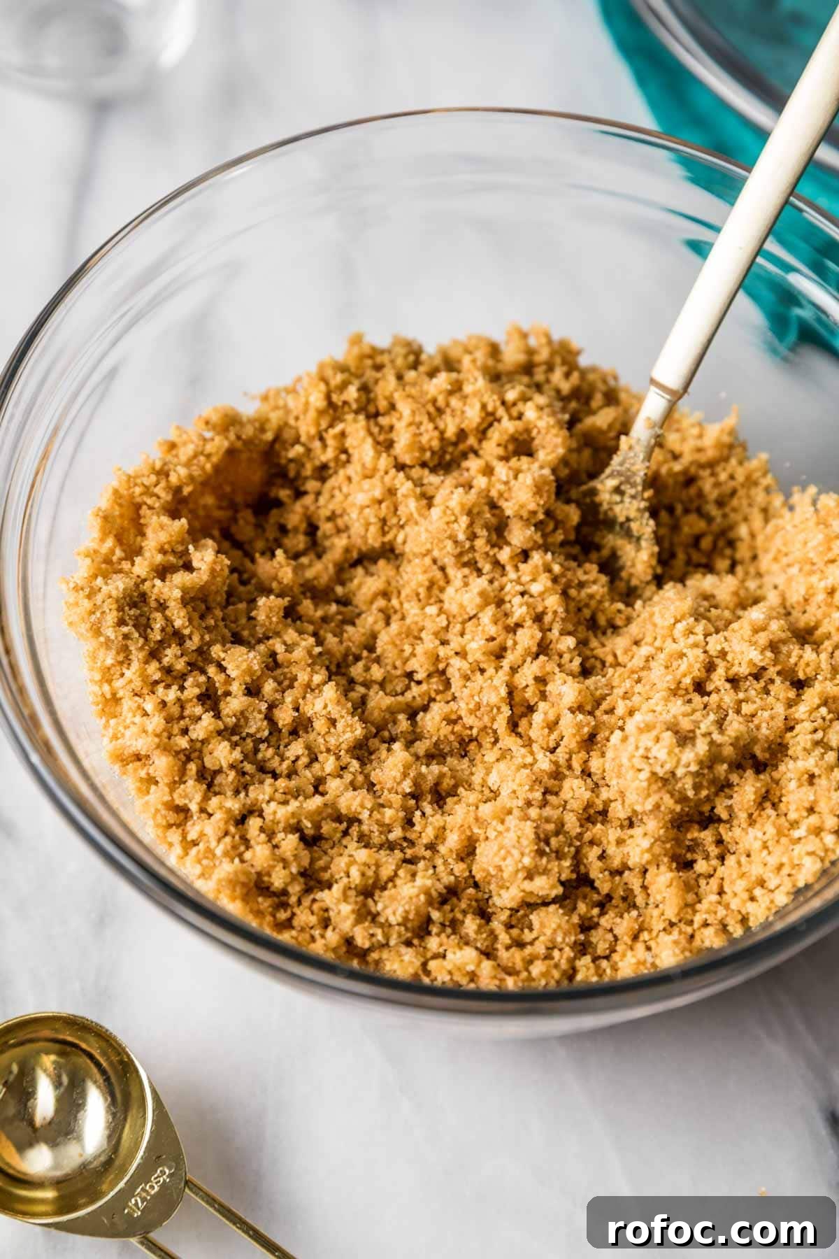 Graham Cracker Crust Recipe: Simple Steps for Perfect Pie Crust 7 Fork tossing graham cracker crumbs together with butter and sugar.