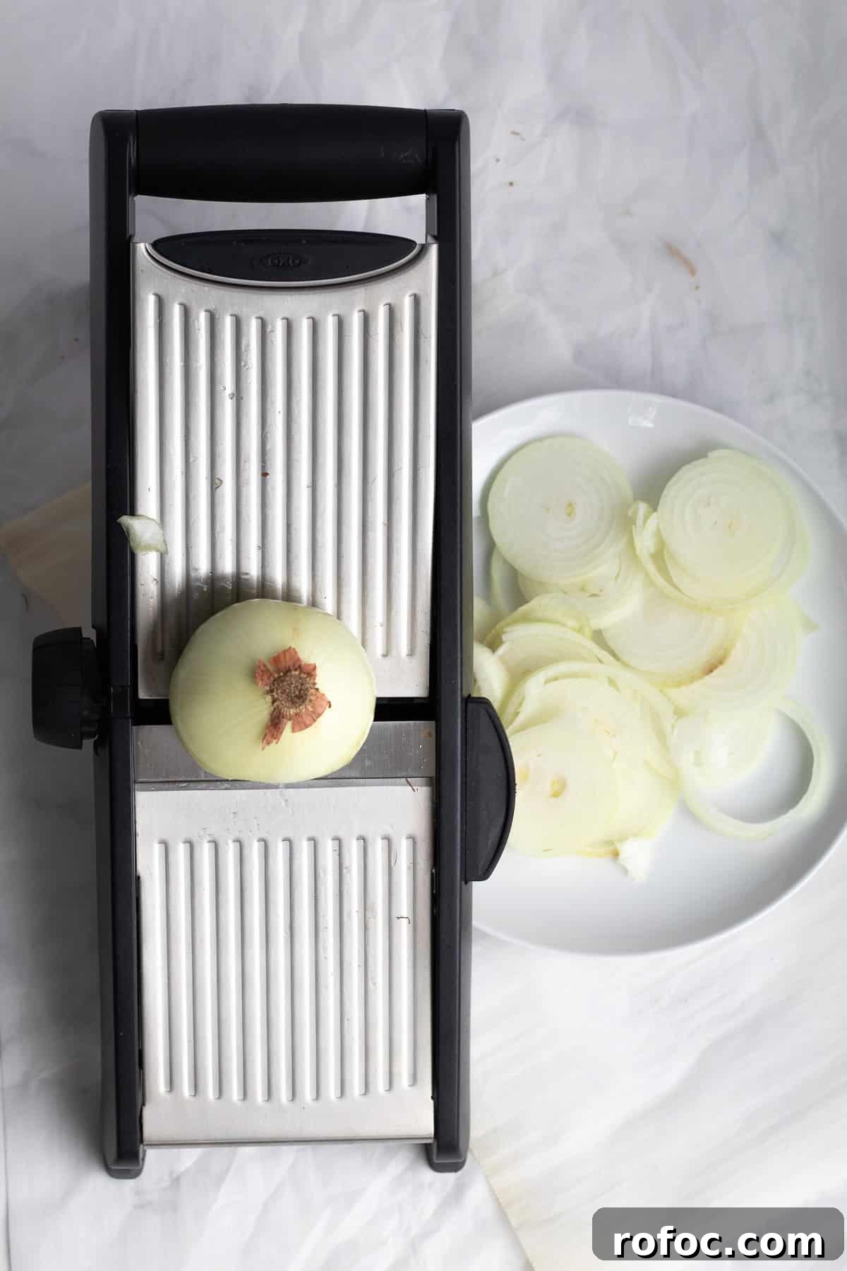 a mandoline with sliced onions