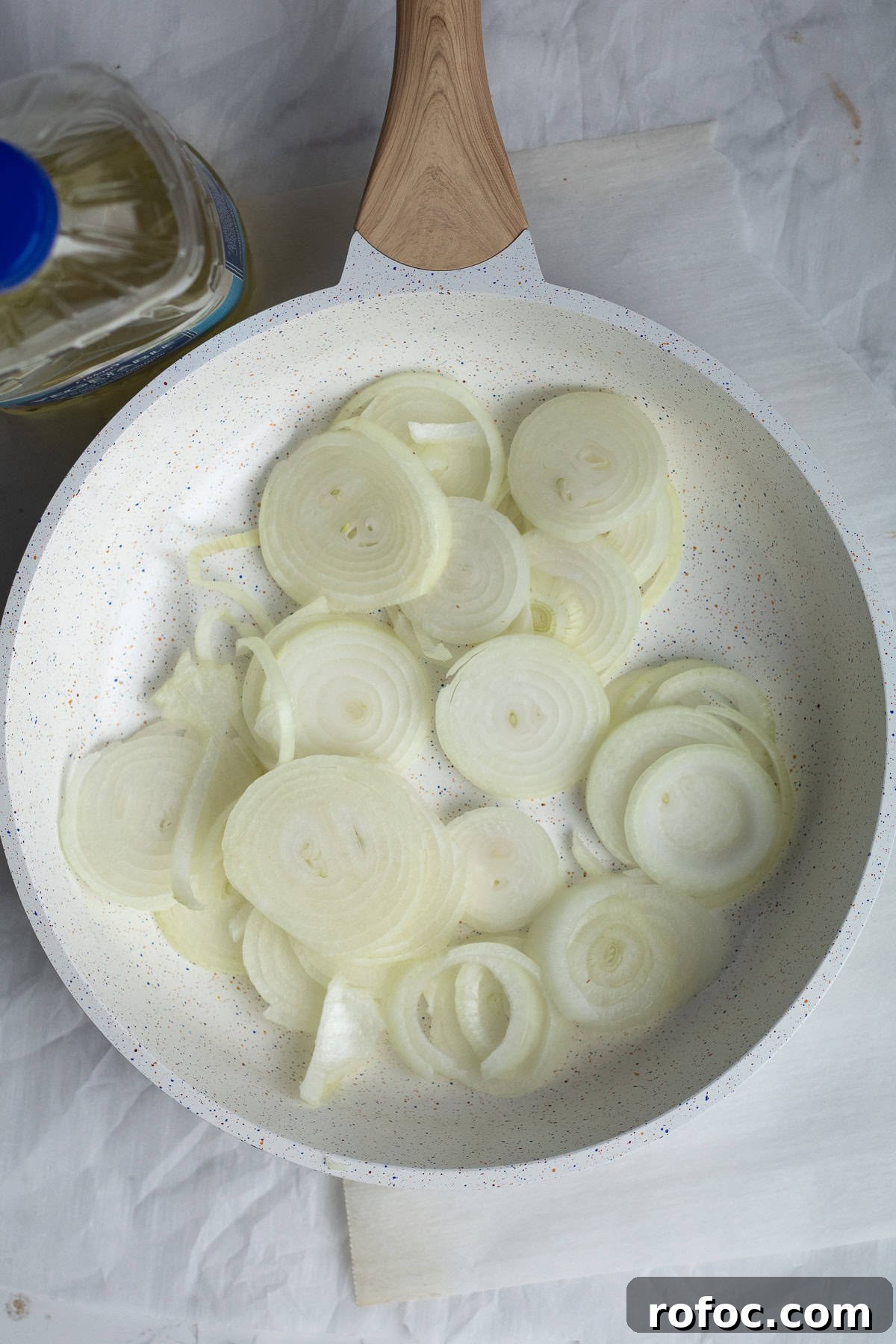 Sliced onions in a frying pan