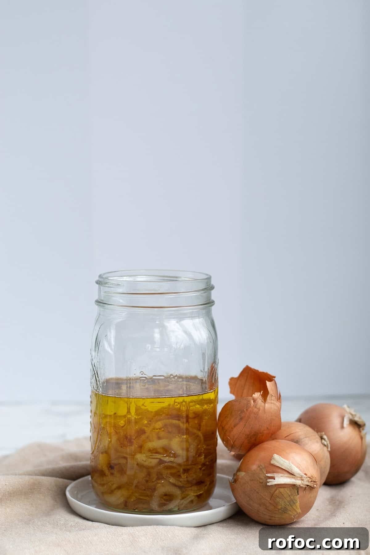 mason jar of onion oil on counter