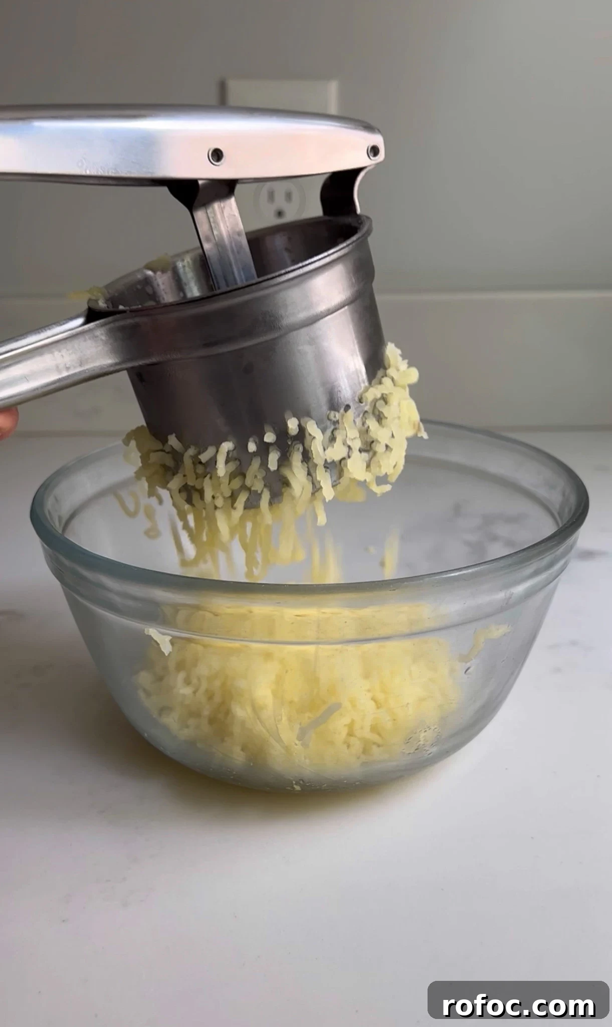 Ricing the potatoes for bread.