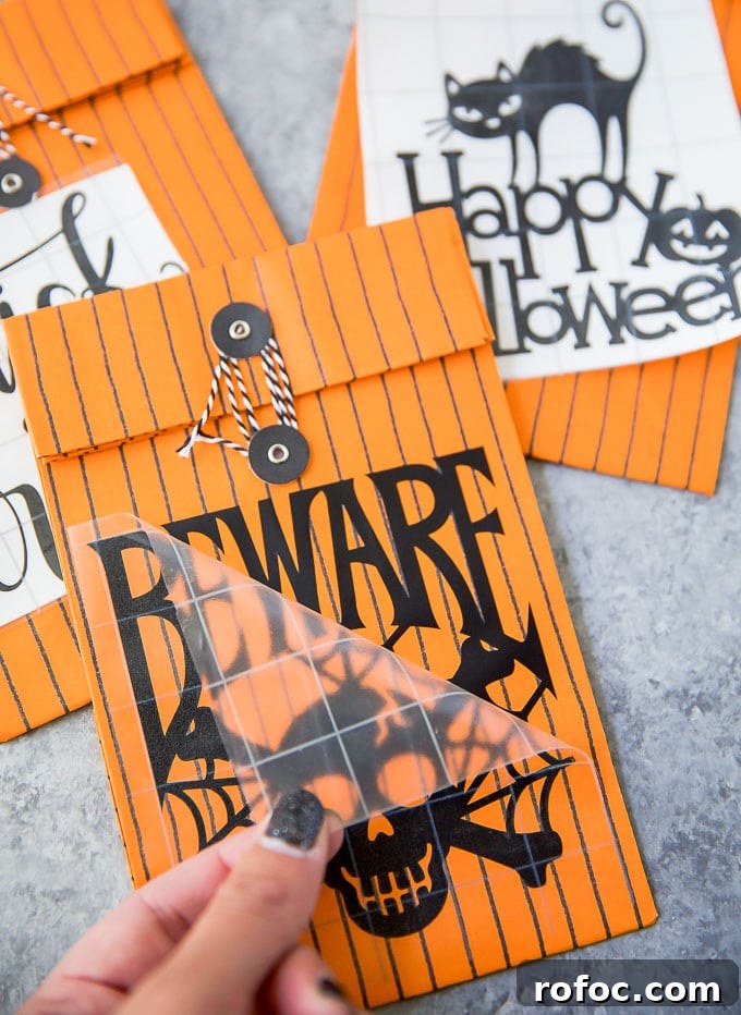 DIY Halloween Treat Bags Kids Will Love 8 how to apply vinyl to paper treat bags
