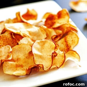 A plate of crispy cinnamon apple chips.