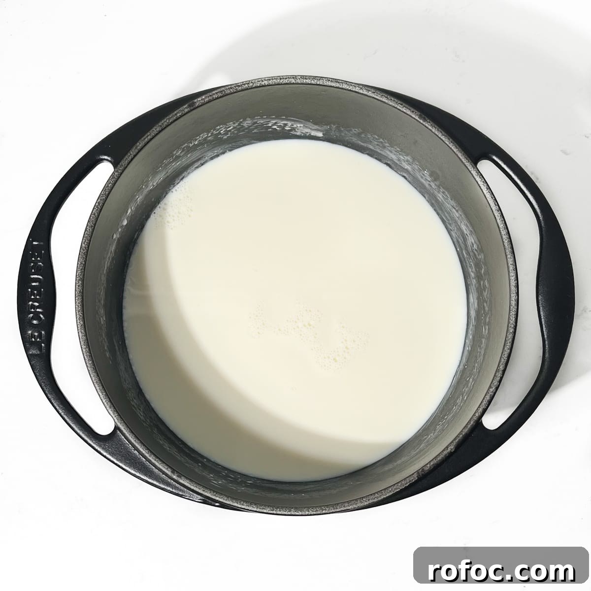 Milk in a black saucepan.