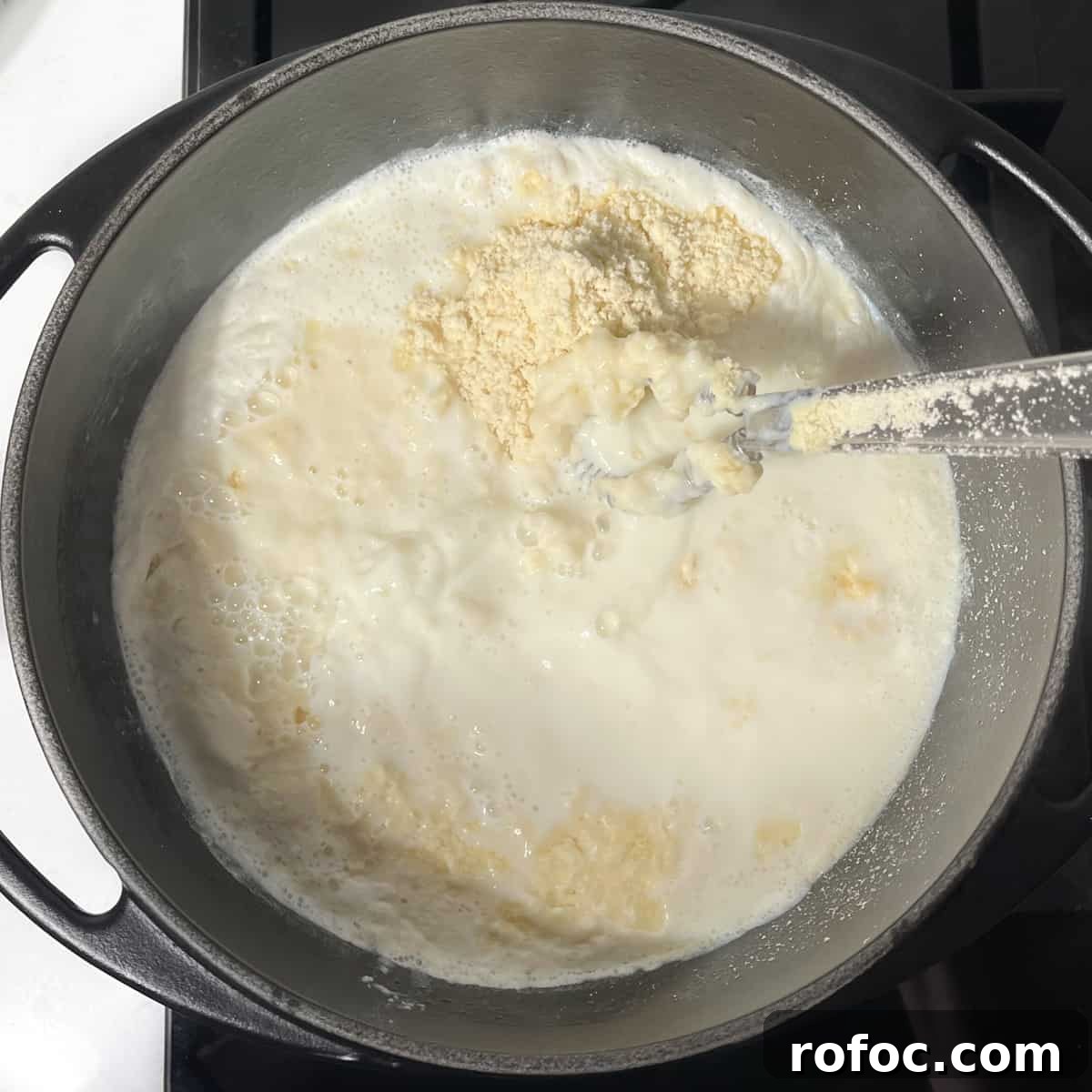 Whisking the flour and butter crumbs into the melkkos.