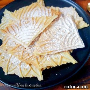pile of wafer cookies on black plate.