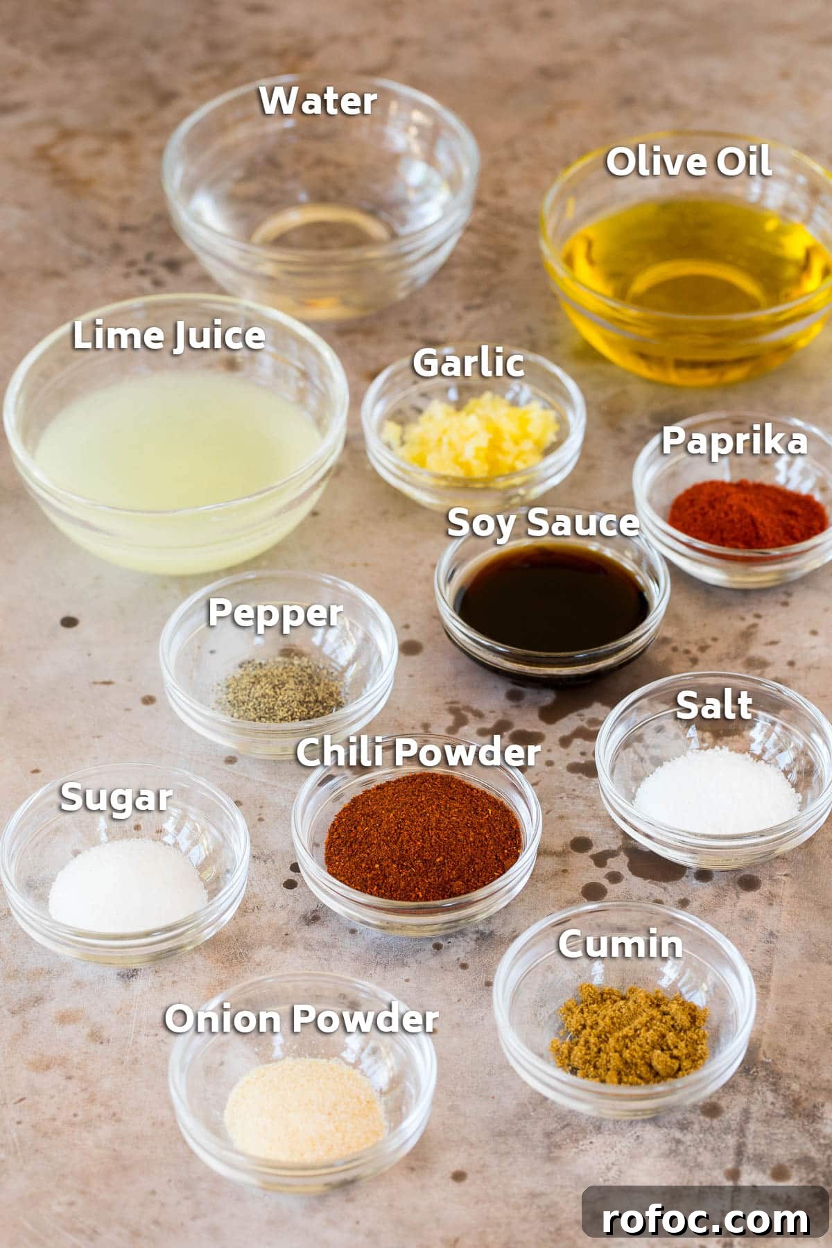 Bowls of ingredients including oil, lime juice, garlic and spices.
